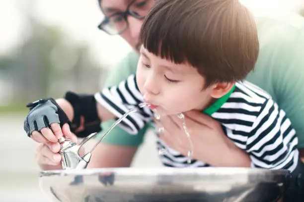 Photo of Little boy drinking tap water