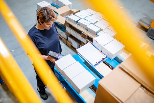 high angle view of warehouse employee using bar code reader for scanning information - bar code reader wireless technology computer equipment imagens e fotografias de stock