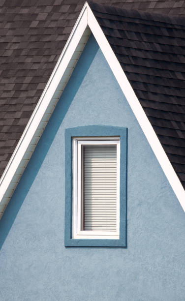 istock Grey roof, blue walls with window and white paintwork details. Minimalistic style. 1054970440