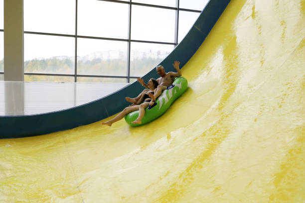 istock Grandfather and granddaughter on slide 1054970690
