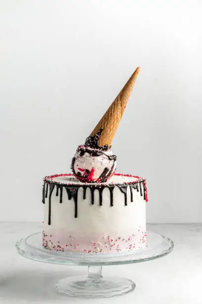 Ice cream cone birthday layer cake on a white background. Vertical. Free space for text.