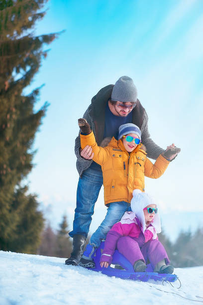 istock Father and His Children Having Fun with the Sled 1054970930