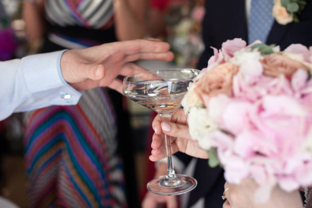 istock Man's hand reaches for a martini glass 1054970990