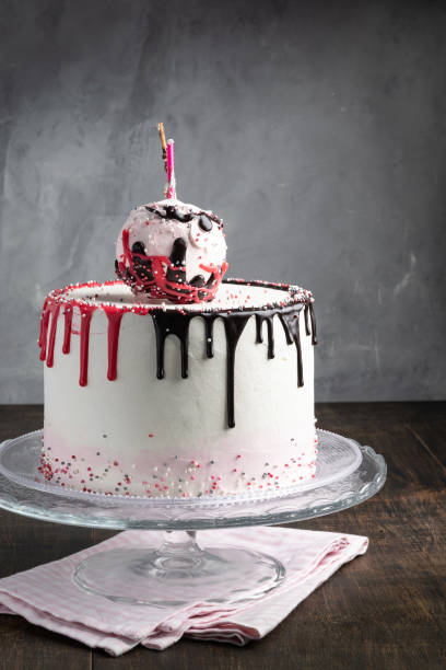 istock Birthday Drip Cone Cake with sprinkles on a gray background. Making cake decoration. Copy space. Celebration concept. Trendy Cake. Vertical. 1054971034