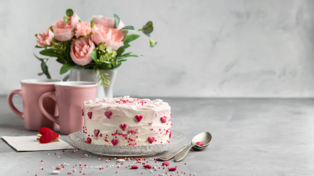 istock Cake with small hearts and colorful sprinkles on a plate with coffee. Grey stone background. Romantic love concept. Valentine's day, Mother's Day, Birthday Cake card. Valentines day background banner. 1054971142