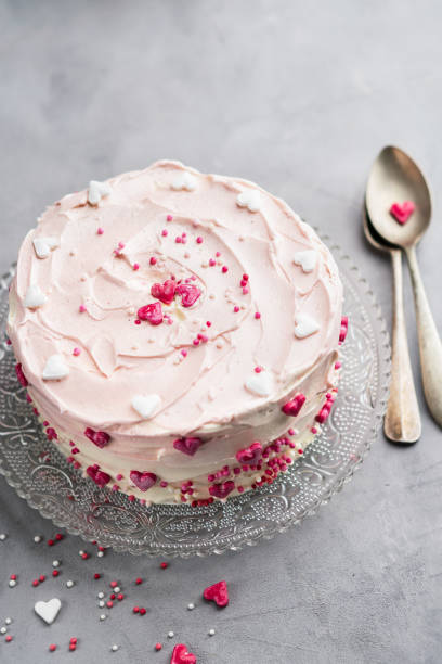istock Cake with small hearts and colorful sprinkles on light background. Romantic love background. Valentine's day card. St. Valentine's Day, Mother's Day, Birthday Cake Background Banner. Copy space. 1054971148