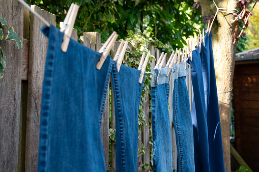 Jeans and pants hanging on clothesline to dry naturally