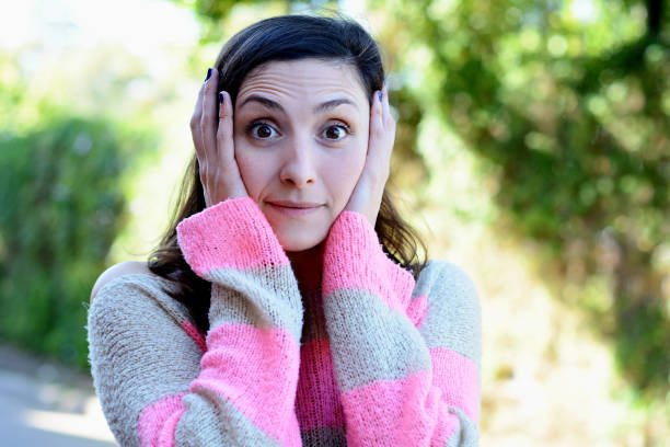 istock Young woman with surprised expression. Outdoor. 1054976402