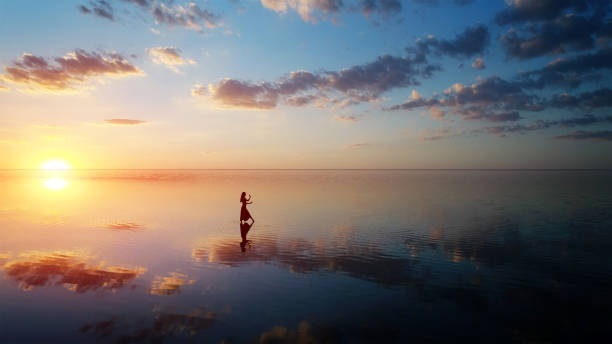 istock Ballerina dancing on the lake at sunset. 1054976726
