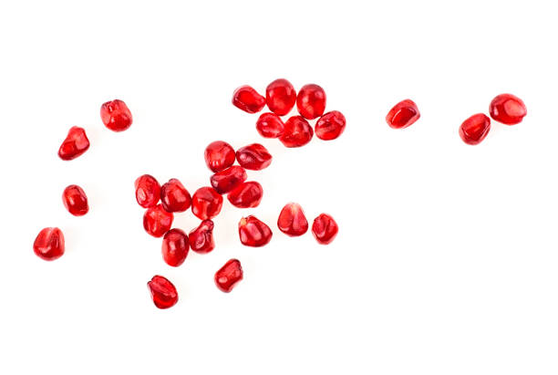 istock Seeds of pomegranate isolated on white background. Top view. 1054977274
