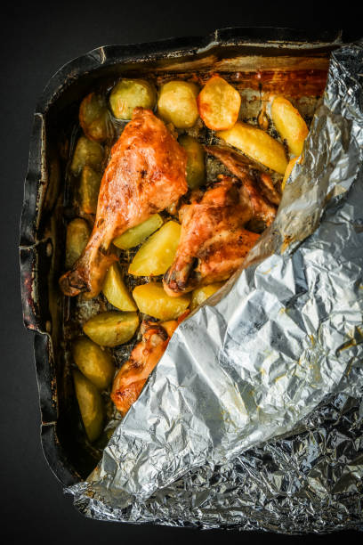 Chicken meat, drumsticks with potatoes and basil