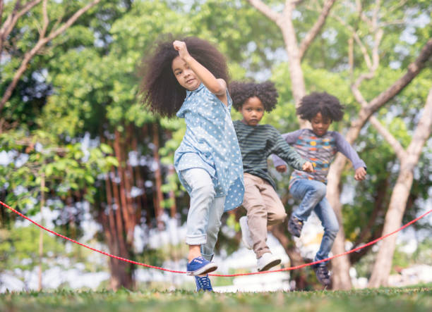 istock kids playing jump over the rope. 1054987732
