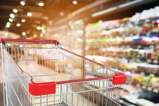 istock supermarket grocery store with fruit and vegetable shelves interior defocused background with empty red shopping cart 1054987810