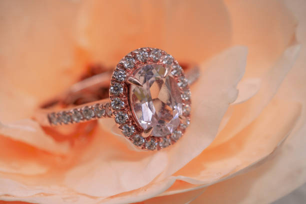 istock pink diamond ring on rose flower background 1054987886