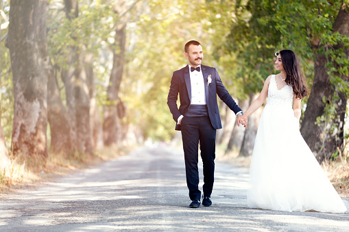 Young married couple is woking on the beautiful road