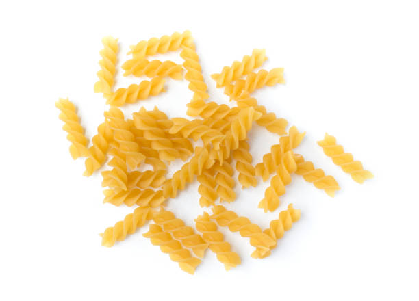 istock uncooked macaroni isolated on a white background. Dry macaroni pasta isolated 1054988244