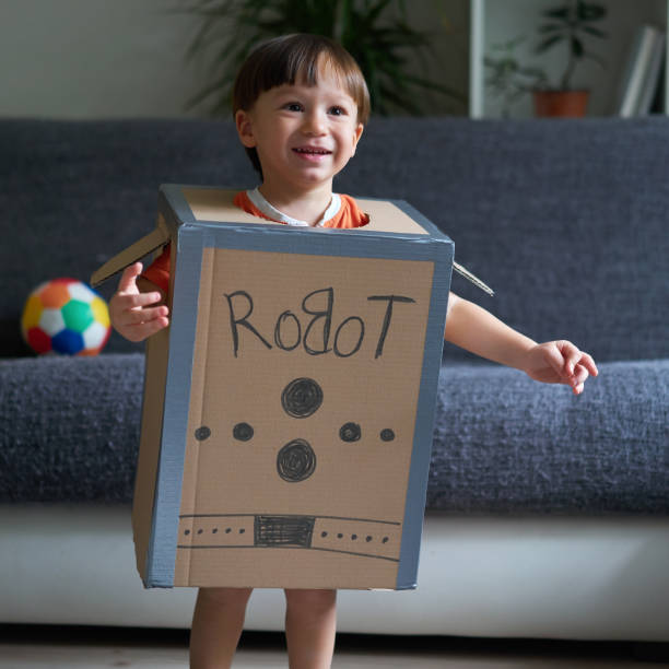 istock Cute child is wearing robot costume 1054989770