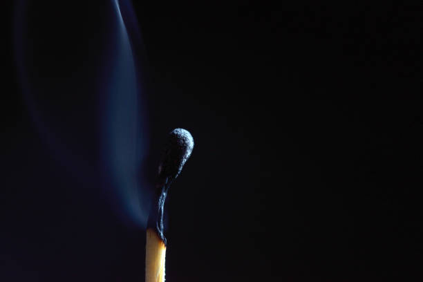 istock burned out wooden matches on black background 1054991364