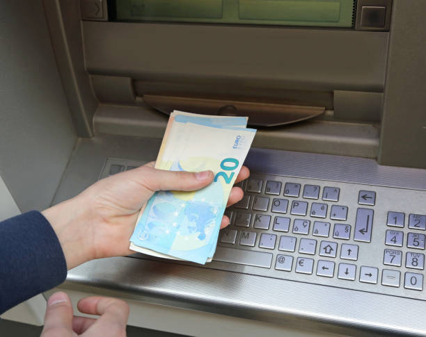 istock Young boy at ATM and many Euro banknotes 1054991674