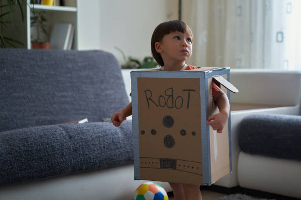 istock Cute child is wearing robot costume 1054992214