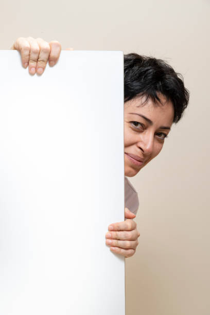 istock Woman Looking Towards Camera Behind Copy Space 1054994000