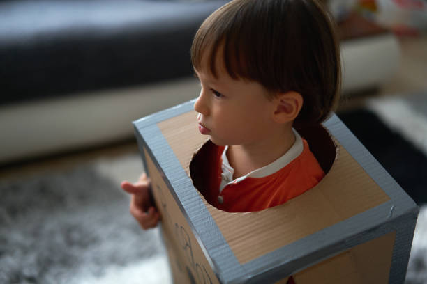 istock Cute child is wearing robot costume 1054994020