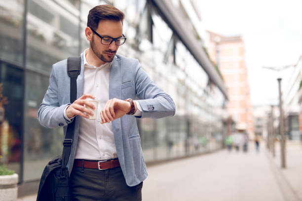 istock Businessman checking the time on his wrist watch 1054994094