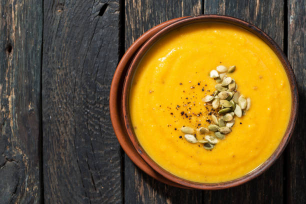 istock pumpkin soup on wooden background 1054994118