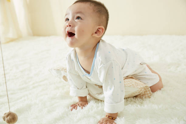 istock In the baby's bedroom, a little boy is playing happily alone 1054994462