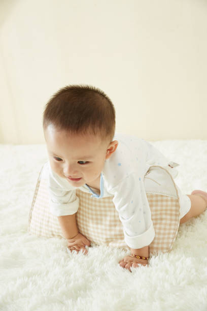 istock In the baby's bedroom, a little boy is playing happily alone 1054994468