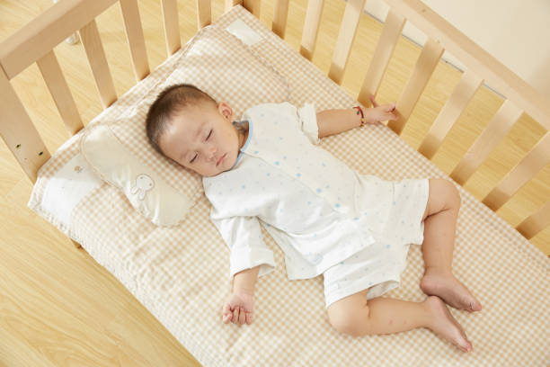 istock The little boy in the crib fell asleep 1054994590