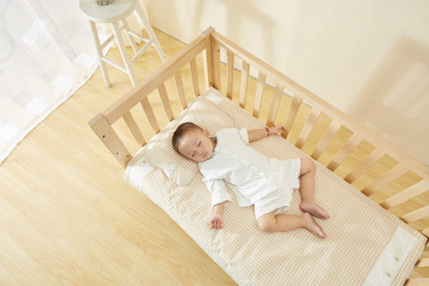 istock The little boy in the crib fell asleep 1054994634