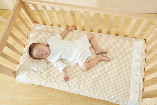 istock The little boy in the crib fell asleep 1054994638