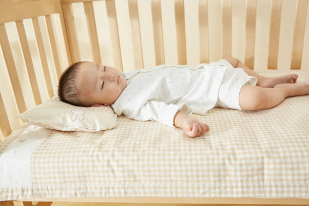 istock The little boy in the crib fell asleep 1054994716