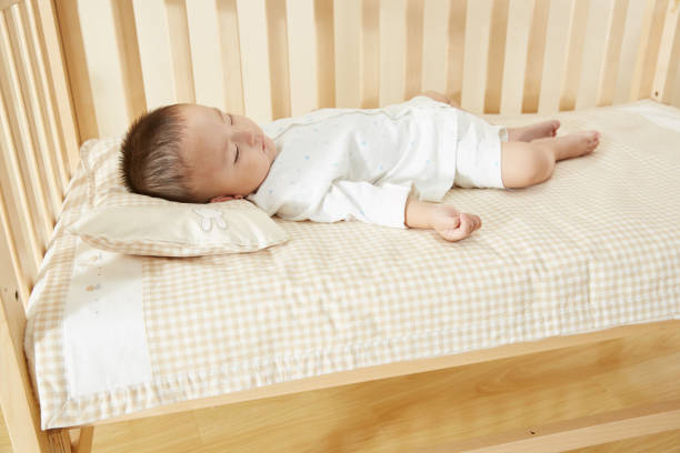 istock The little boy in the crib fell asleep 1054994718