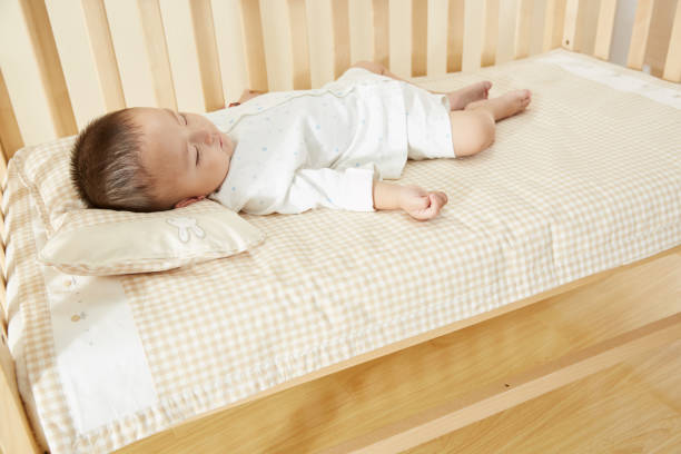 istock The little boy in the crib fell asleep 1054994722