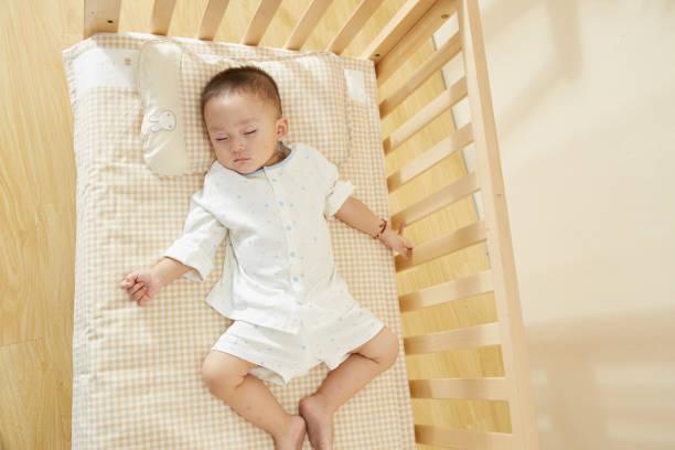 istock The little boy in the crib fell asleep 1054994724