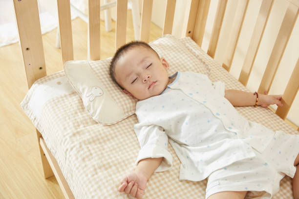 istock The little boy in the crib fell asleep 1054994764
