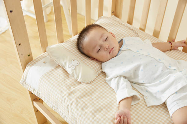 istock The little boy in the crib fell asleep 1054994774