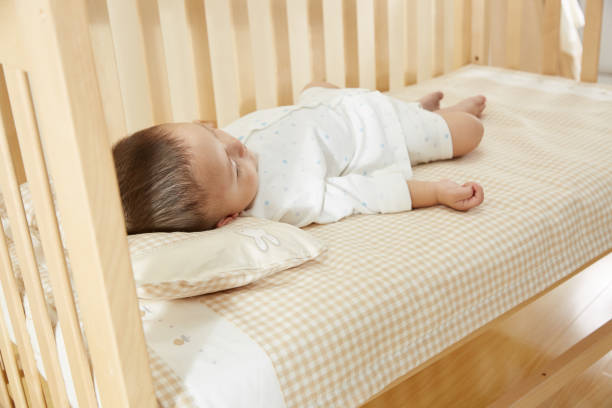 istock The little boy in the crib fell asleep 1054994814