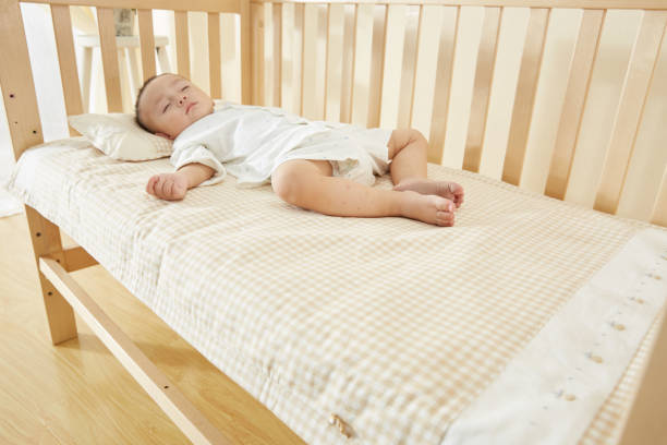 istock The little boy in the crib fell asleep 1054994824