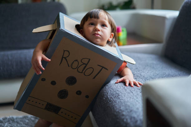 istock Cute child is wearing robot costume 1054996440