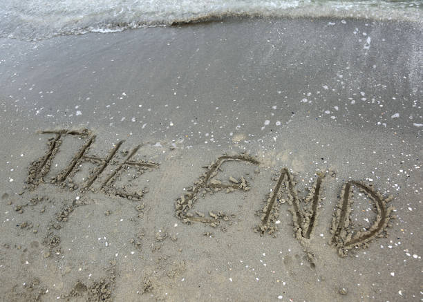 istock word the end written on the sand 1054996468
