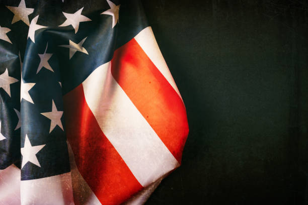 istock American flag on dark background 1054999920