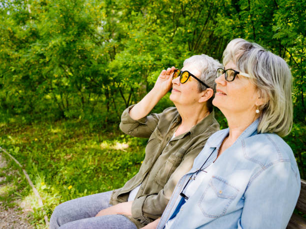 istock Two senior friendly women in a park 1055001902