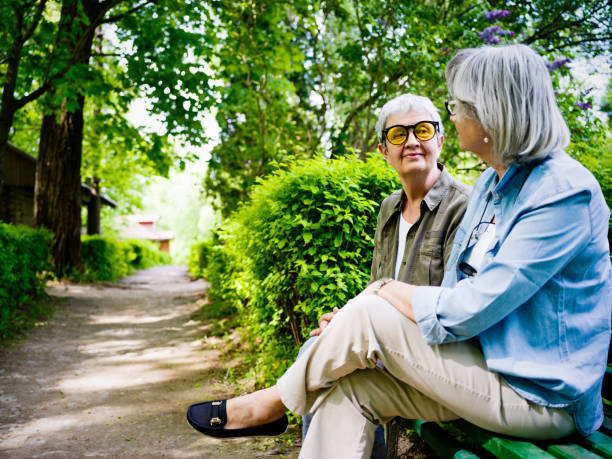 istock Two senior friendly women in a park 1055001982