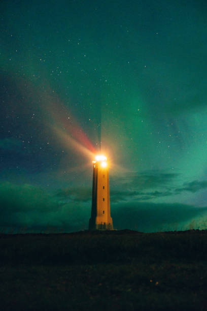 istock Aurora Borealis over lighthouse in Iceland 1055002500