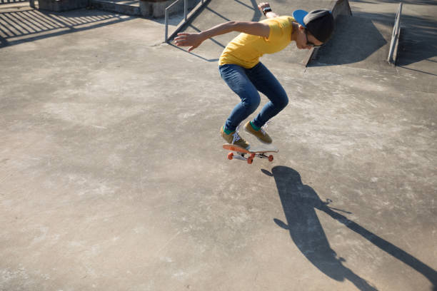 istock Skateboarder doing ollie at skatepark 1055003092