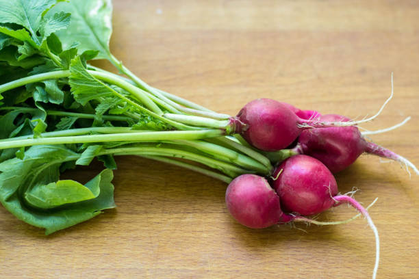 istock bunch of red radish from a garden bed on a rural table 1055003404