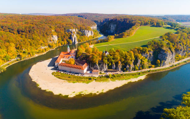 Aerial view to landscape near Weltenburg Abbey - Kloster Weltenburg on the Danube in Bavaria, Germany.. The Danube Gorge - Weltenburg Narrows or Weltenburger Enge. Camera flight over a wonder of nature in Bavaria, Germany. European rivers from above. monastery stock pictures, royalty-free photos & images